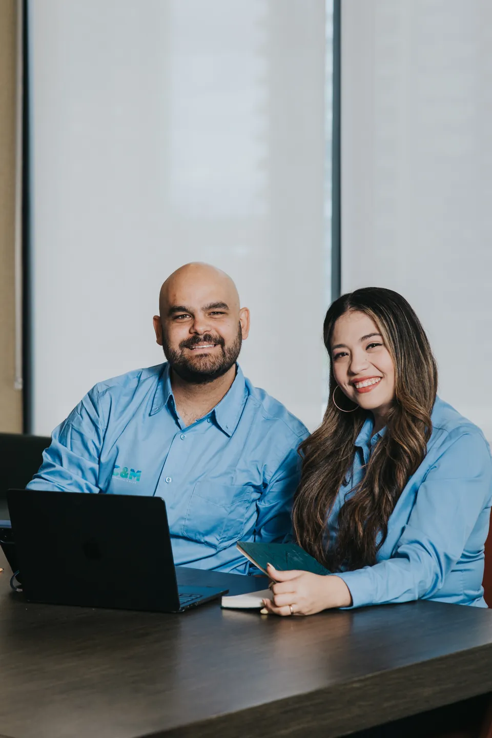 Two C&M team members working together